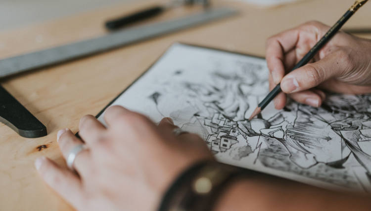 Close up image of Reinaldo Gil Zambrano drawing with pencil. Close up image of Reinaldo Gil Zambrano drawing with pencil.