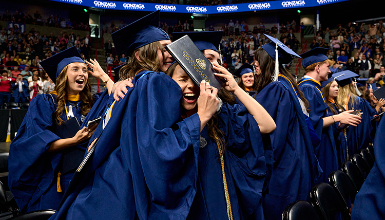 body-commencement-26-students-celebrating Students hugging at Commencement.
