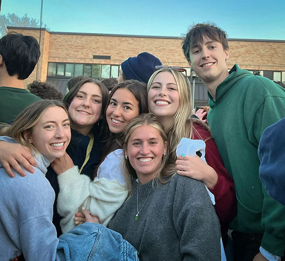 A group of Gonzaga Students smiling and hugging.