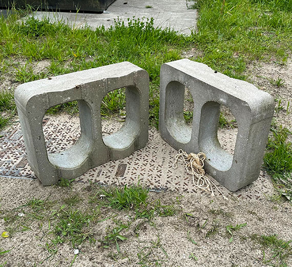 two large concrete blocks with two oval holes inside.