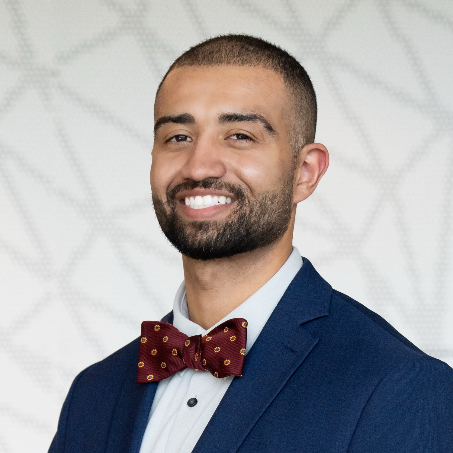 A smiling man in a bow tie