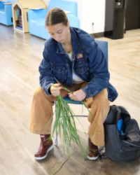 Hannah-Gangwish-Havre-Montana-200x250.jpg A seated woman weaving grass.