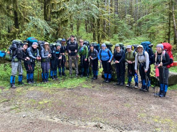 Gonzaga students in hiking gear on group hike in the woods Gonzaga students in hiking gear on group hike in the woods