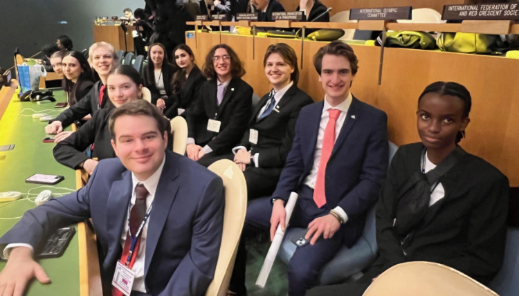Gonzaga University Model United Nations delegates seated inside the United Nations Headquarters during the NMUN 2025 conference. The photo shows rows of desks with country nameplates, official conference badges, and participants preparing for committee sessions. Gonzaga University Model United Nations delegates seated inside the United Nations Headquarters during the NMUN 2025 conference. The photo shows rows of desks with country nameplates, official conference badges, and participants preparing for committee sessions.