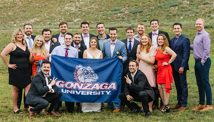 large wedding party with gonzaga flag