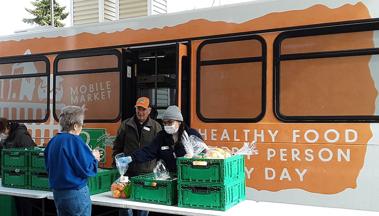 April Lopez, Gonzaga alumna and Americorps member, assists at food distribution. April Lopez, Gonzaga alumna and Americorps member, assists at food distribution.