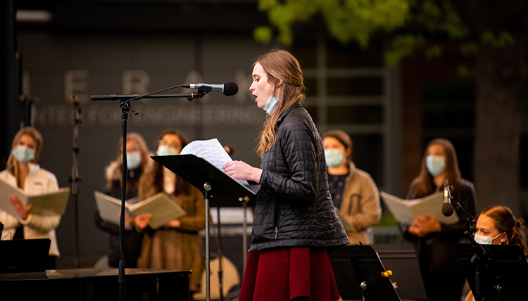 a female student leads portions of the liturgy at Mass a female student leads portions of the liturgy at Mass