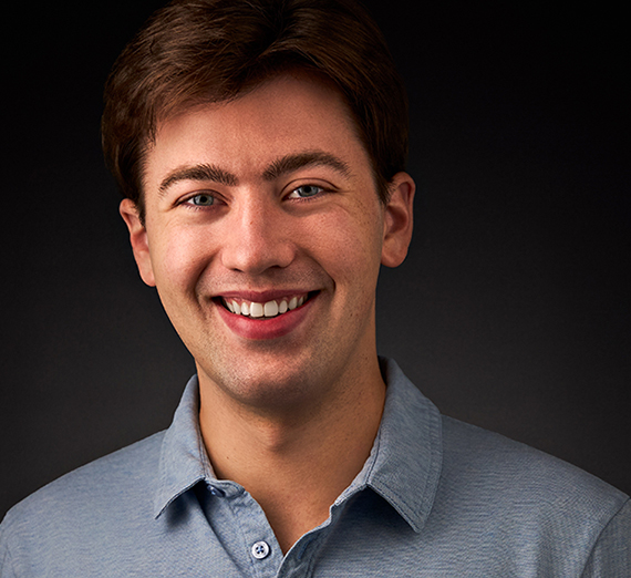 A smiling man in a blue-collared shirt Nic Marshall