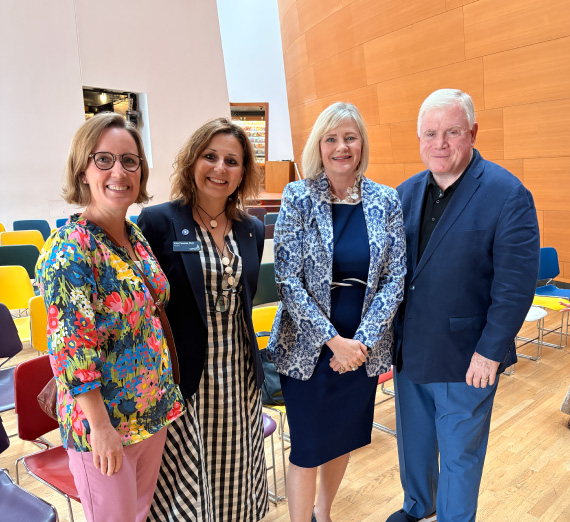 Gonzaga President Passerini poses with three attendees of the Forging Forward Los Angeles event.