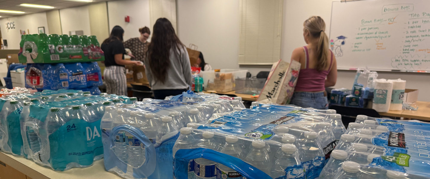 Volunteers collecting donations of bottled water for distribution.