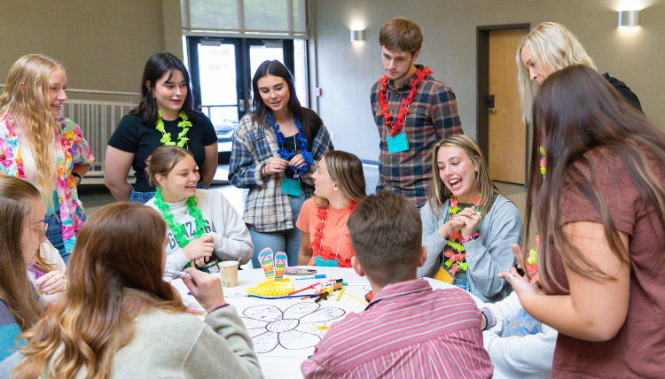 Counselor Education students gather at a table to discuss an activity Counselor Education students gather at a table to discuss an activity