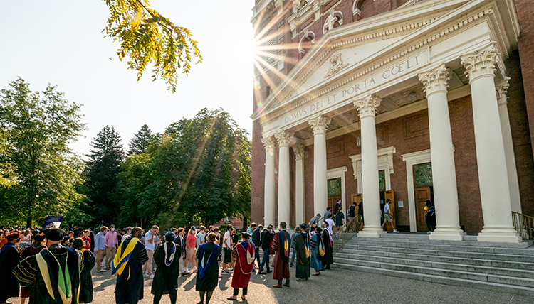 Gonzaga Community outside St. Al's Church faculty lining up at St. Aloysius church backlit by sun