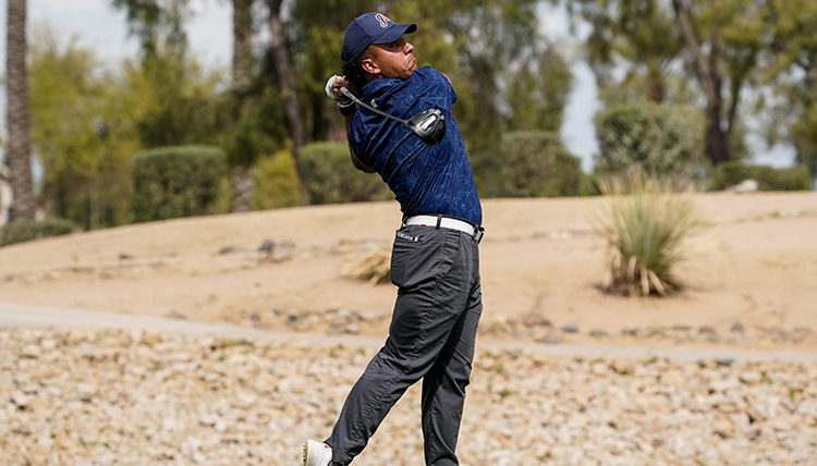 A man swings a golf club A man swings a golf club