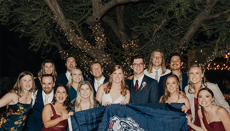 large wedding group with gonzaga flag