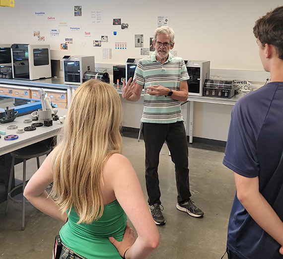 Two students with 3d printers Two students with 3d printers