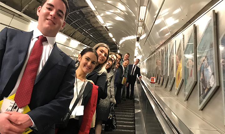 Students pose on the escalator in the London metro. Students pose on the escalator in the London metro.
