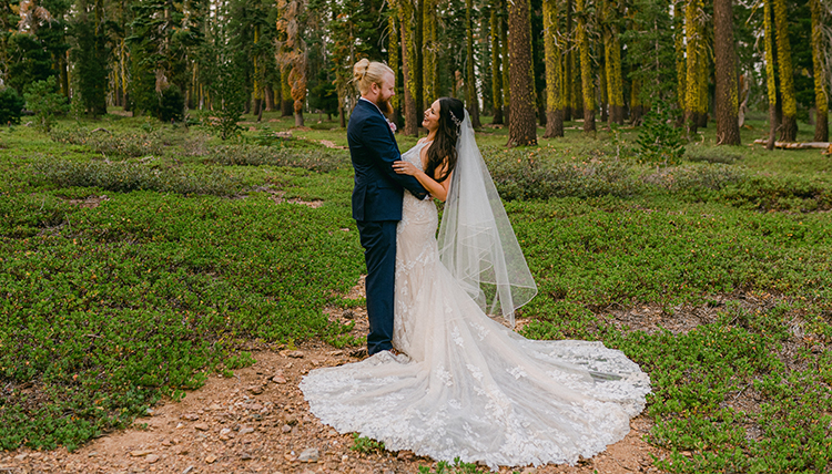 Man and woman pose in wedding outfits in forest. Man and woman pose in wedding outfits in forest.