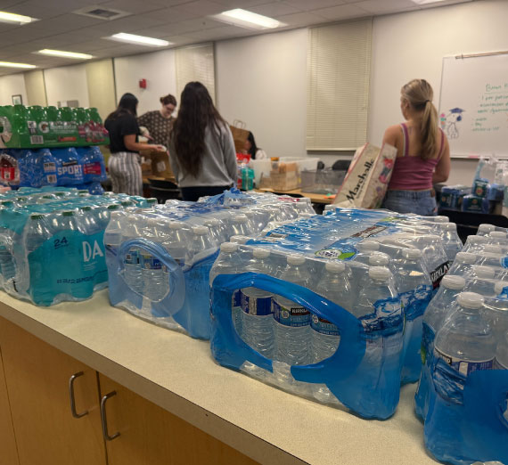 Volunteers collecting donations of bottled water for distribution.