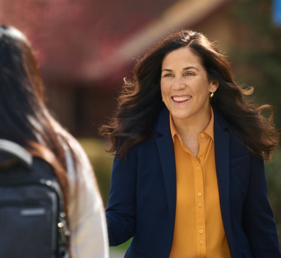 Woman looks at person and smiles.