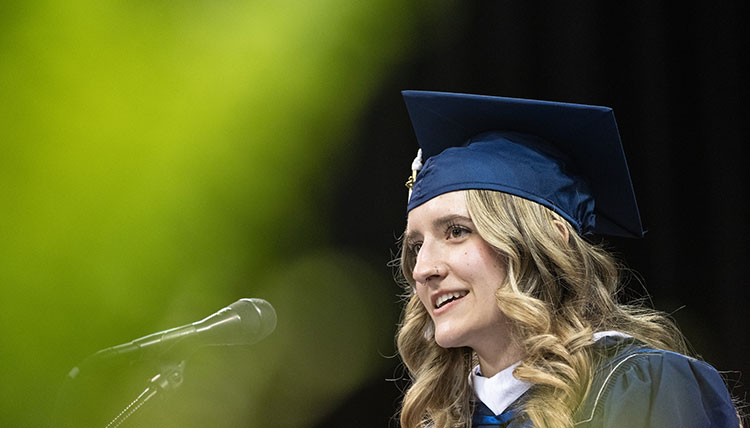 Undergraduate Commencement student speaker Rachel Gotvald speaks into a microphone Undergraduate Commencement student speaker Rachel Gotvald speaks into a microphone