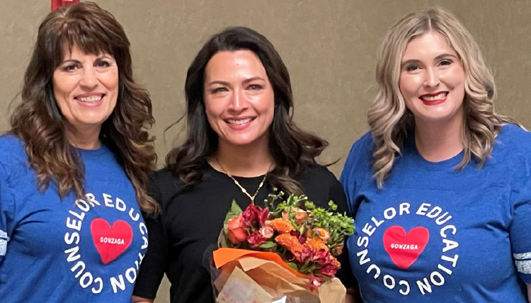 Three women posing for a photo, facing the camera. Three women posing for a photo, facing the camera.