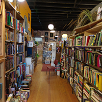 Book shelves on either side of an aisle in Giant Nerd Bookstore Book shelves on either side of an aisle in Giant Nerd Bookstore