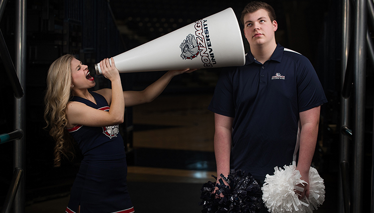 cheerleader yelling through bullhorn to bored brother cheerleader yelling through bullhorn to bored brother