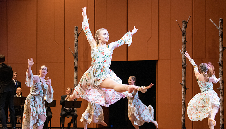 dancers leaping on stage at Woldson PAC dancers leaping on stage at Woldson PAC