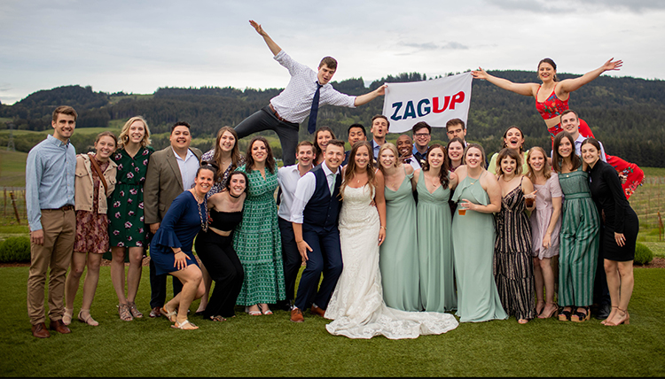 large wedding party outdoors with gonzaga flag