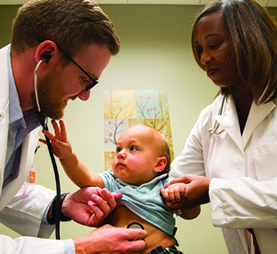 Second-year medical student Kenley Unruh with pediatric patient and instructor Dr. Cicely White in Spokane.