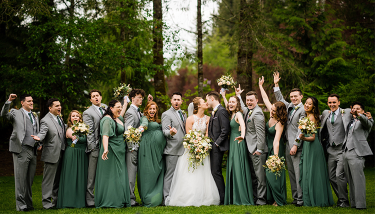 large wedding party outdoors in green and gray large wedding party outdoors in green and gray