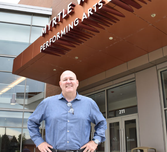 Man standing in front of a building