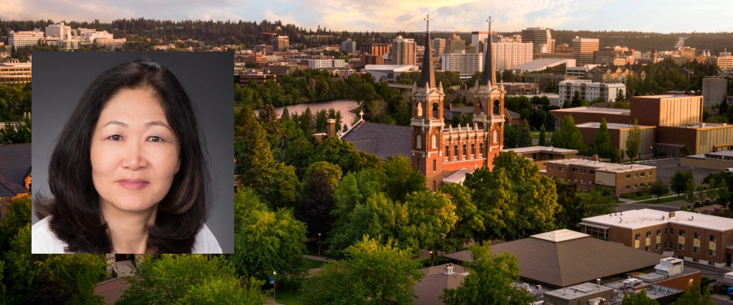 Dr. Francisca Cho's picture set over an aerial shot of the Gonzaga University campus and St. Aloysius Catholic Church.