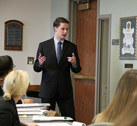 Joe Parry stands in front of a mock trial court room. Joe Parry stands in front of a mock trial court room.
