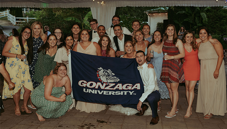 group of friends and couple holding gonzaga flag group of friends and couple holding gonzaga flag
