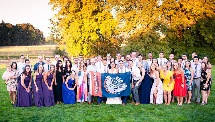 large wedding party outdoors with people holding bulldog flag large wedding party outdoors with people holding bulldog flag