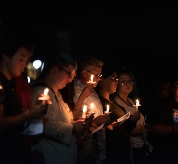 community members hold candles for vigil in support of migrants and refugees at the southern border