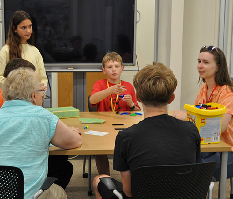 Campers play Legos and games with Foley Librarians