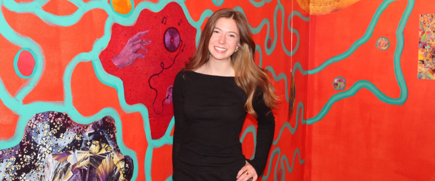 Gonzaga University Neuroscience and Art Student Ava Knap in front of her exhibit 