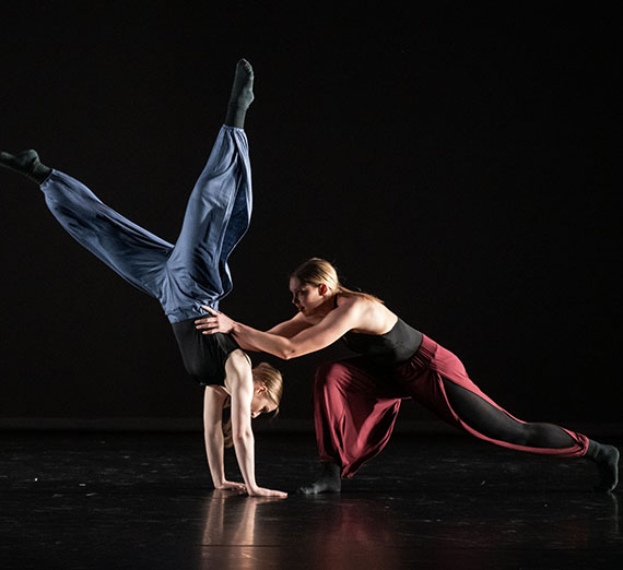 Two dancers pose on stage. Two dancers pose on stage.