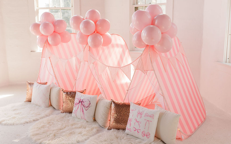 A row of pink sleepover tents. A row of pink sleepover tents.