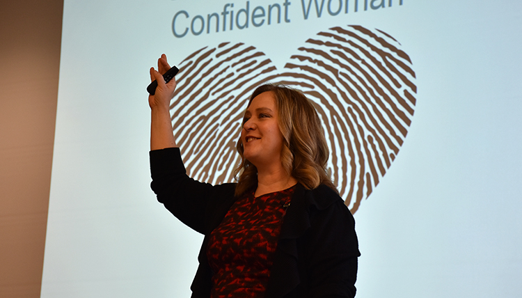 Deanna Davis in front of slide about women Deanna Davis in front of slide about women