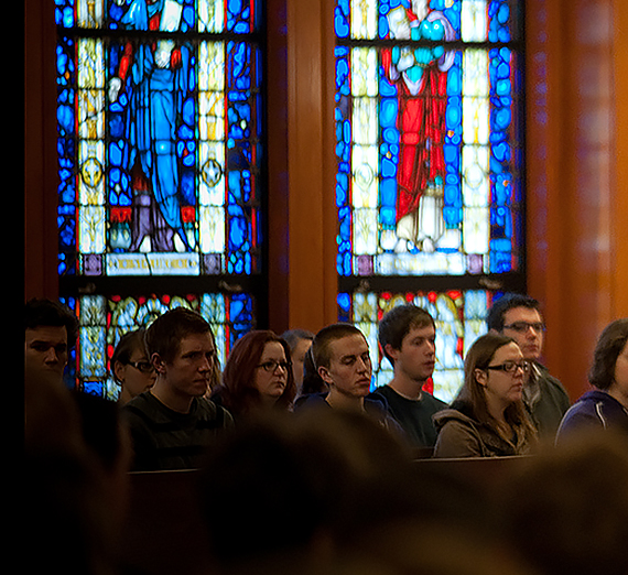 Students listen to a lecture. Stained glass is the background. Students listen to a lecture. Stained glass is the background.