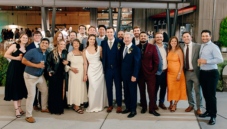 A group of people smiling at a wedding. A group of people smiling at a wedding.