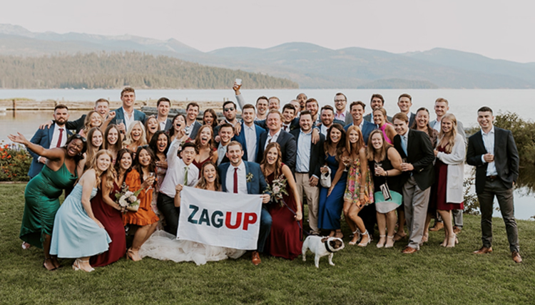 large wedding party with gonzaga flag