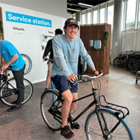 Student poses sitting on a bike. Student poses sitting on a bike.