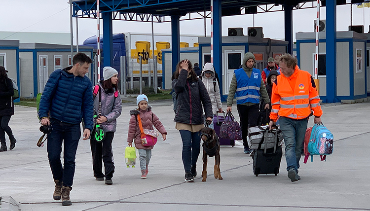 Eli Francovich walks with a Ukrainian refugee family. Eli Francovich walks with a Ukrainian refugee family.