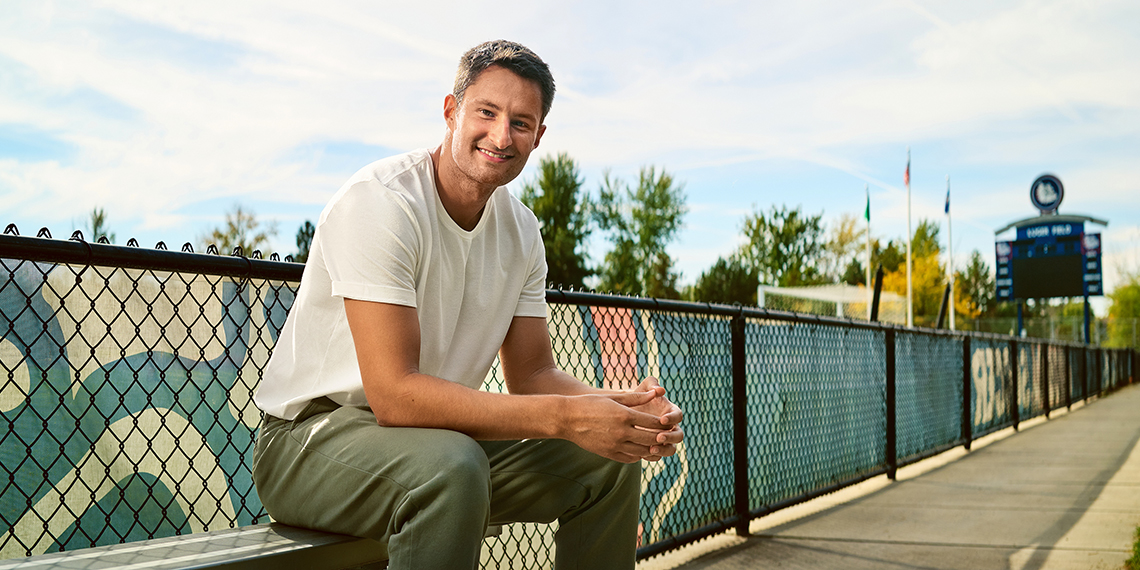 A man sitting on a bench outside