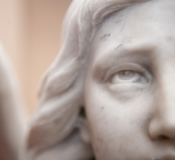 A statue of an angel looks up outside of St. Aloysius. A statue of an angel looks up outside of St. Aloysius.