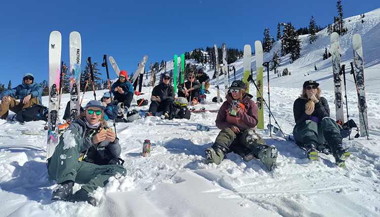 skiiers on a mountain take a break skiiers on a mountain take a break